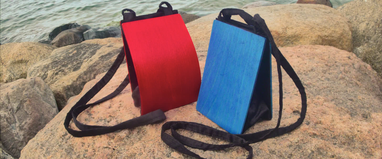Blue and red bags on a rock