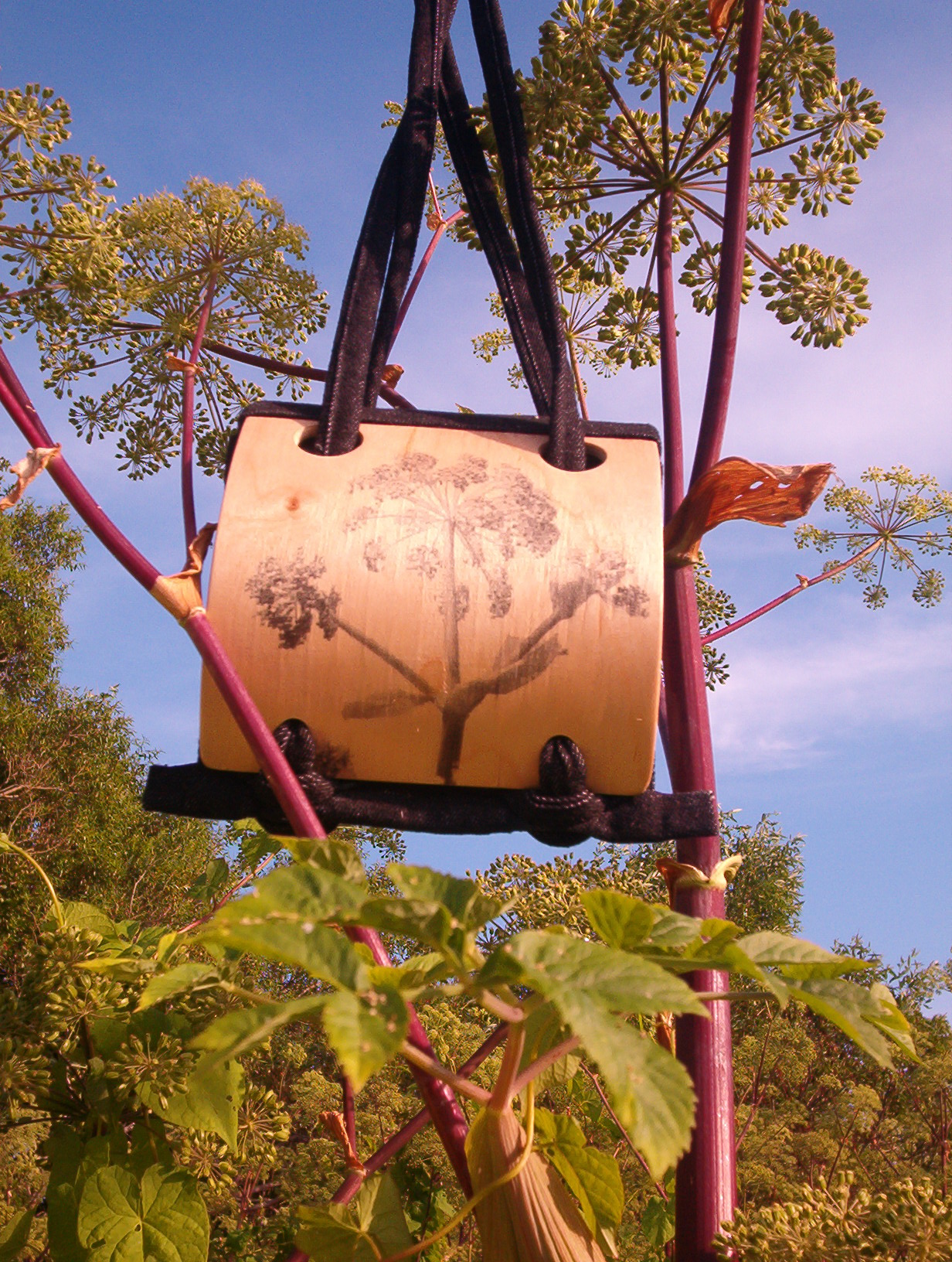 wooden bag with a picture of a tree in the middle of trees