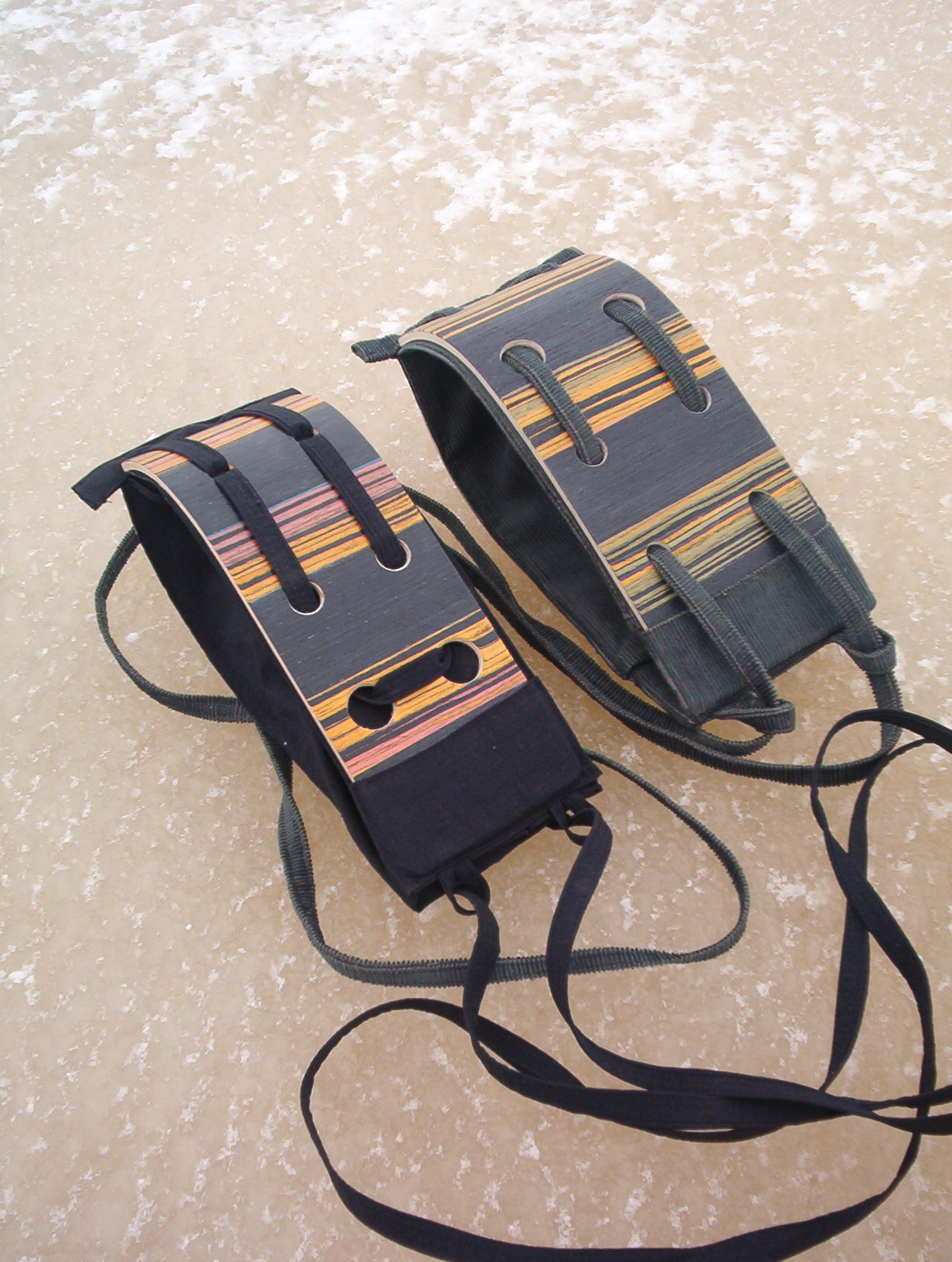 two black wooden intarsia bags with orange and red stripes